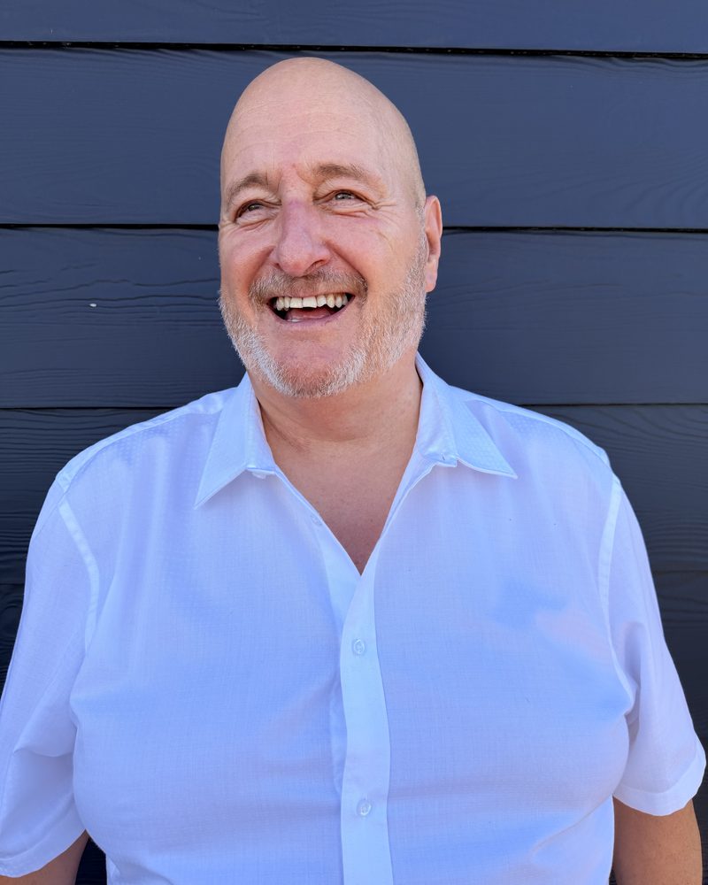 Darrell Grayson, founder of The Junction, smiling in a white shirt